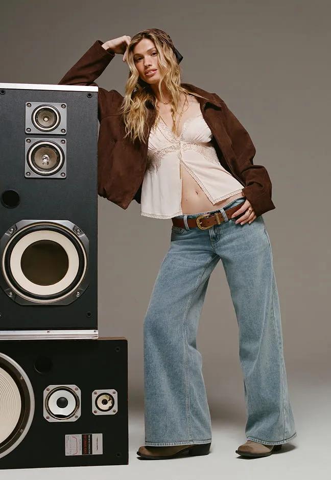 Wide-leg jeans styled with a lace top and brown jacket