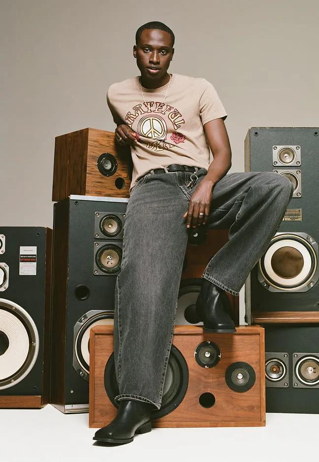 Relaxed jeans styled with a graphic T-shirt and boots